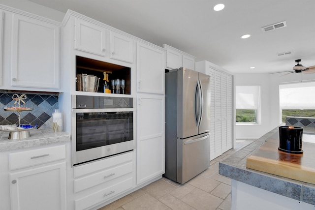 2749 S Ponte Vedra Blvd, Ponte Vedra Beach, FL 32082 - kitchen featuring stainless steel appliances, white cabinets, ceiling fan, tasteful backsplash, and recessed lighting