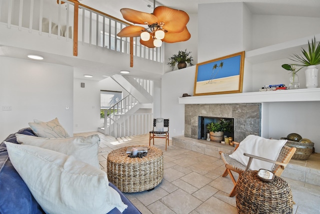 2749 S Ponte Vedra Blvd, Ponte Vedra Beach, FL 32082 - living area with stairs, stone tile flooring, a towering ceiling, a tile fireplace, and a ceiling fan