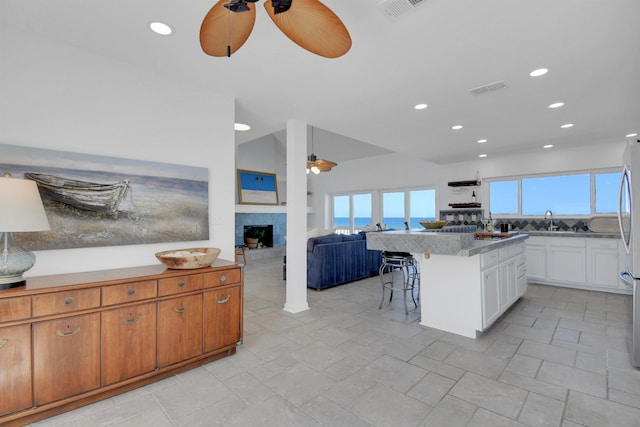 2749 S Ponte Vedra Blvd, Ponte Vedra Beach, FL 32082 - kitchen with ceiling fan, a kitchen breakfast bar, a fireplace, recessed lighting, and open floor plan
