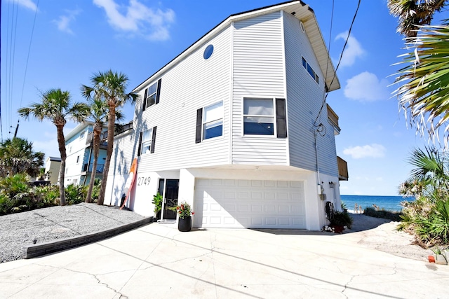 2749 S Ponte Vedra Blvd, Ponte Vedra Beach, FL 32082 - view of front of home with an attached garage, driveway, and a water view