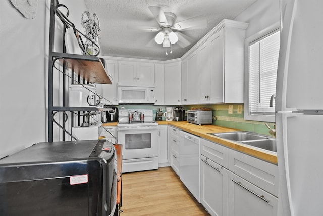2749 S Ponte Vedra Blvd, Ponte Vedra Beach, FL 32082 - kitchen with white appliances, a ceiling fan, white cabinetry, light wood-style floors, and a textured ceiling