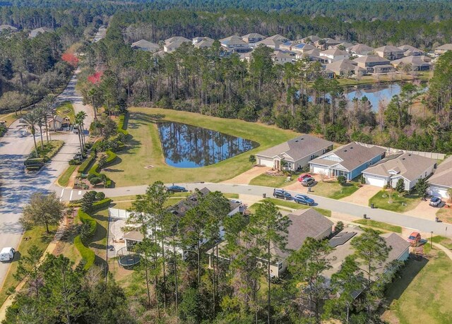 bird's eye view featuring a residential view, a water view, and a forest view