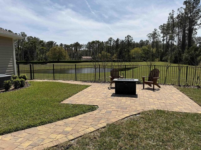 view of yard with cooling unit, a patio area, a fenced backyard, and a fire pit