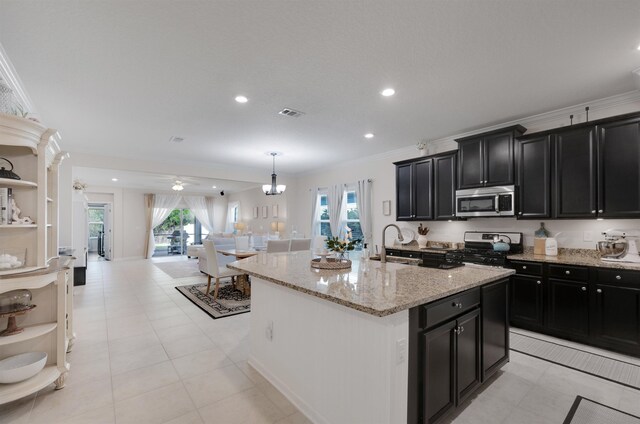 kitchen featuring crown molding, open shelves, appliances with stainless steel finishes, open floor plan, and dark cabinetry