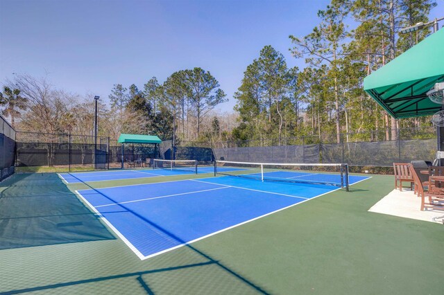 view of sport court with fence