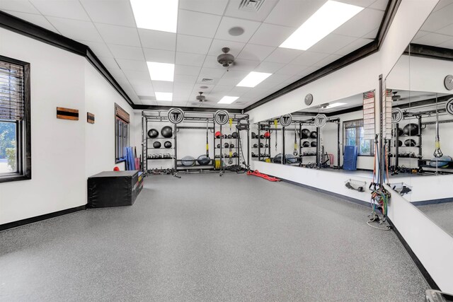 workout area featuring baseboards, visible vents, and a drop ceiling