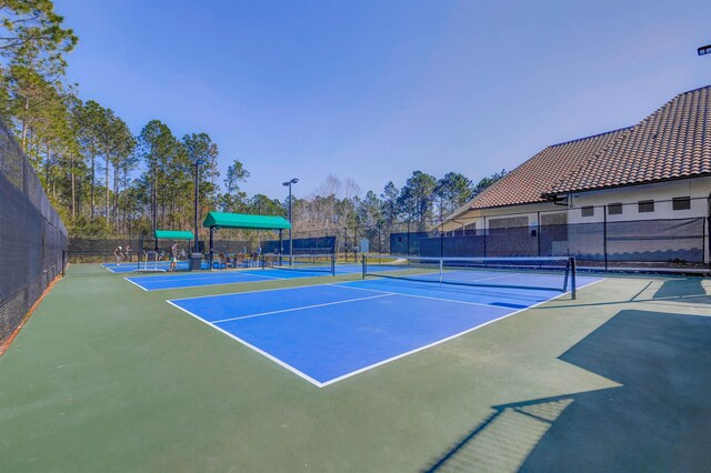 view of sport court with fence