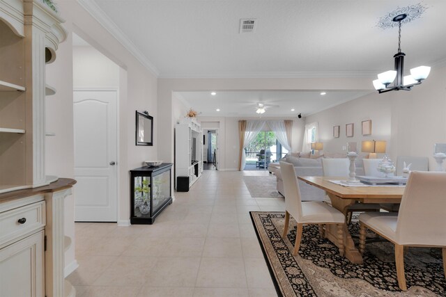 dining space with baseboards, visible vents, ornamental molding, ceiling fan with notable chandelier, and light tile patterned flooring