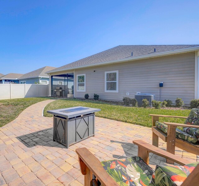 view of patio featuring fence, central AC unit, and grilling area