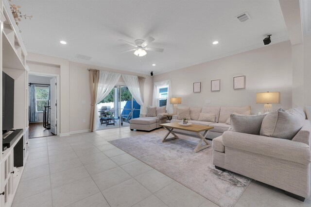 living room featuring plenty of natural light, visible vents, and a ceiling fan