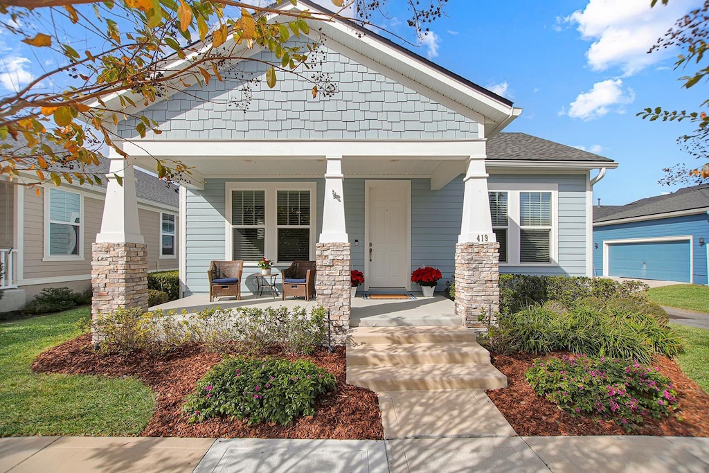 view of front of house with covered porch and a garage