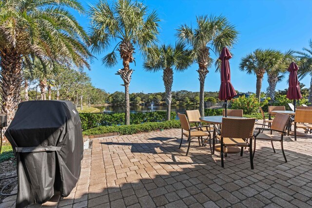 view of patio featuring area for grilling and a water view