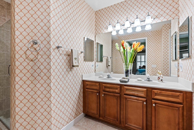 bathroom featuring tile patterned floors, a shower with door, and vanity