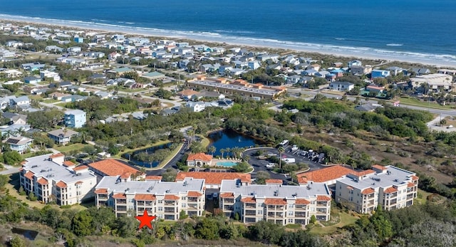 bird's eye view featuring a water view and a view of the beach