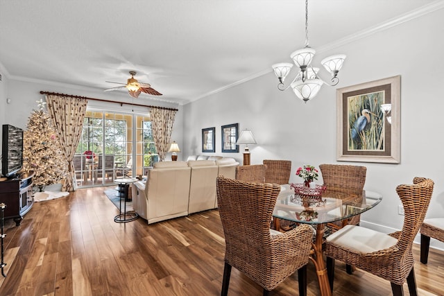 dining room featuring hardwood / wood-style floors, ceiling fan with notable chandelier, and crown molding