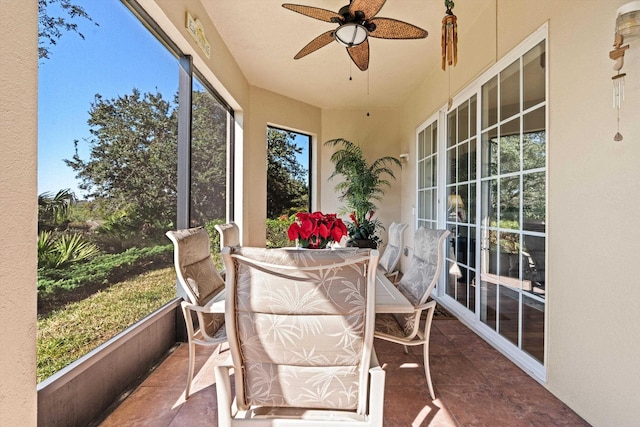 sunroom / solarium featuring ceiling fan