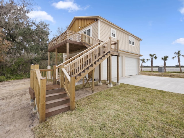 exterior space with a garage, a wooden deck, and a lawn