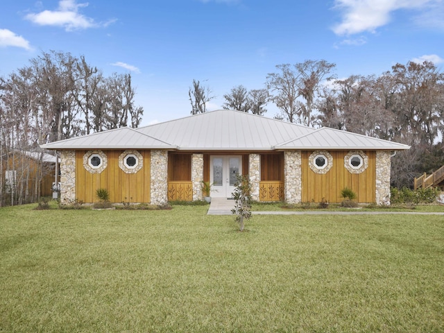 single story home with a front lawn and french doors