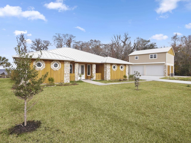 view of front of property featuring a garage and a front lawn