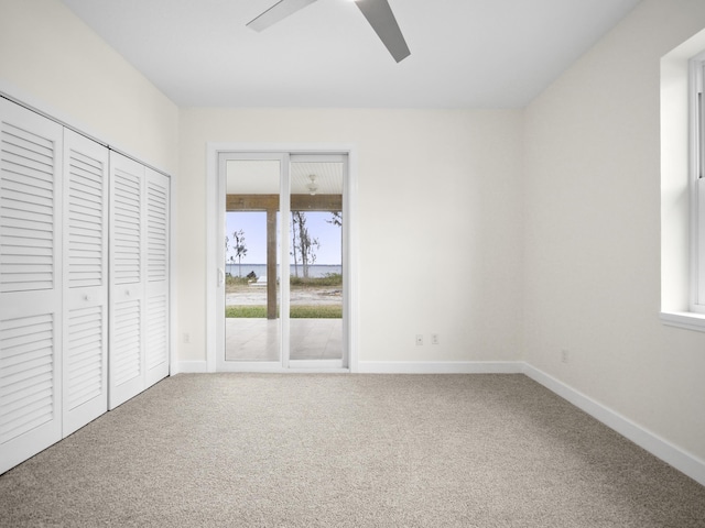 unfurnished bedroom with carpet, access to outside, and ceiling fan