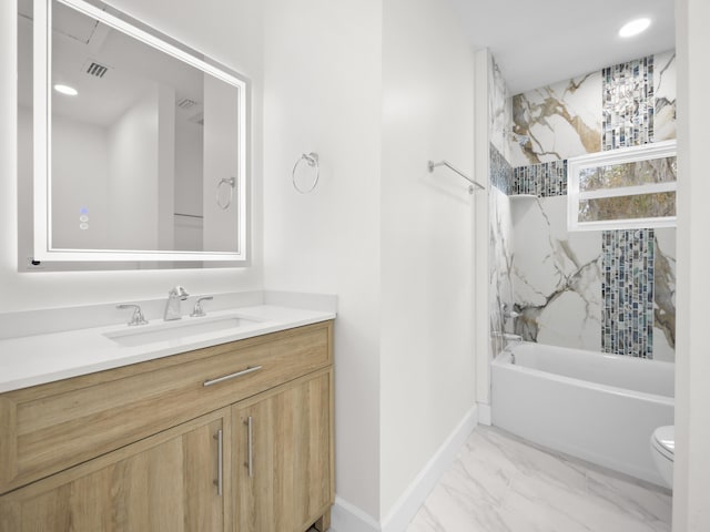 full bathroom featuring vanity, tiled shower / bath, and toilet