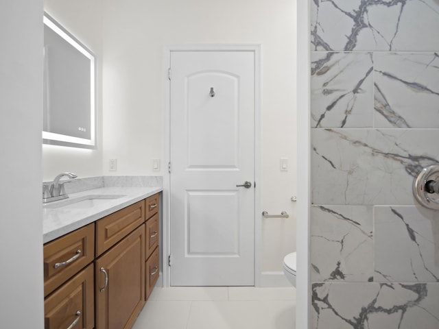 bathroom featuring vanity, toilet, and tile patterned flooring