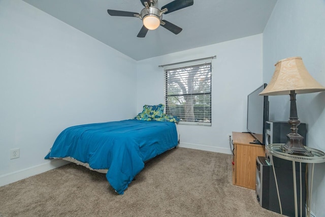 bedroom featuring baseboards, light colored carpet, and a ceiling fan