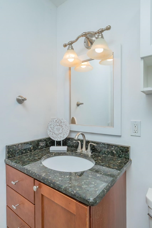 half bathroom featuring toilet and vanity