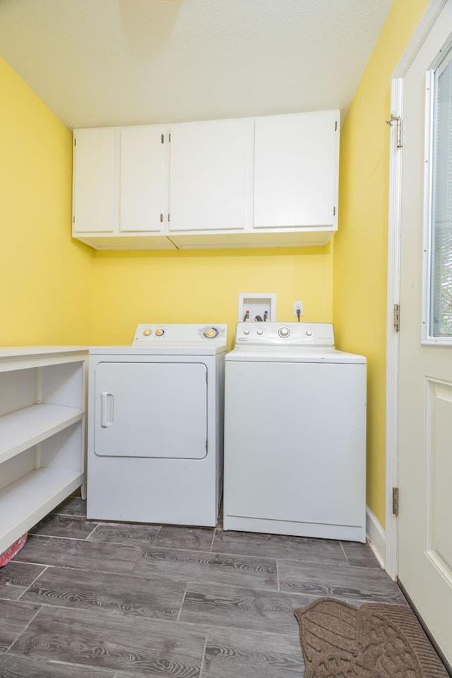 laundry room with washer and dryer, cabinet space, and dark wood-style flooring