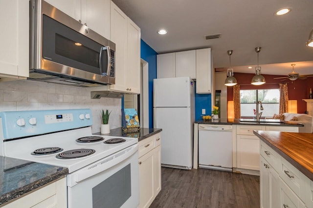 kitchen with visible vents, dark wood-type flooring, white appliances, white cabinetry, and a ceiling fan