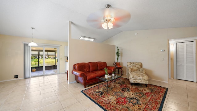 living room with light tile patterned floors, vaulted ceiling, and ceiling fan