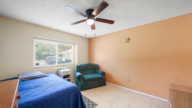 tiled bedroom featuring ceiling fan and a textured ceiling