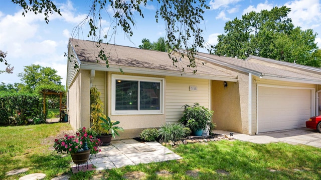 single story home with a garage and a front lawn