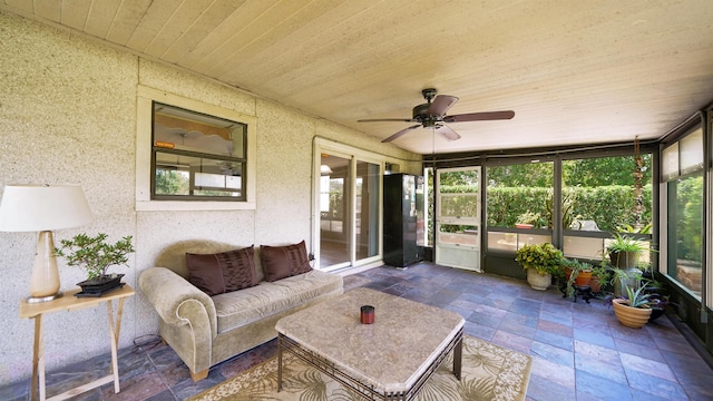 sunroom featuring ceiling fan and wooden ceiling