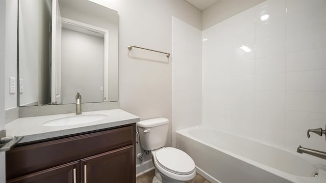 full bathroom with vanity, tiled shower / bath combo, and toilet