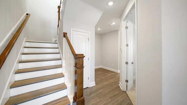 staircase featuring hardwood / wood-style flooring