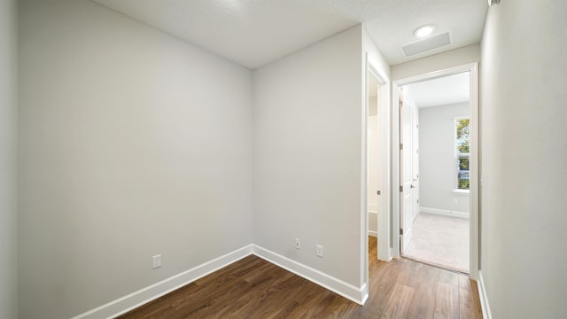 corridor featuring hardwood / wood-style floors