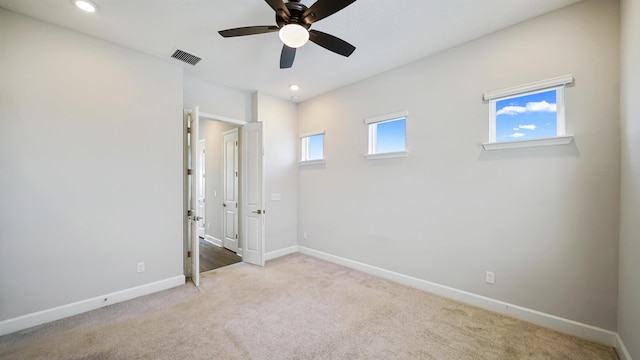 unfurnished bedroom featuring light colored carpet and ceiling fan