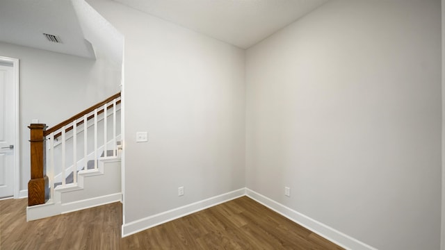 stairway with hardwood / wood-style flooring