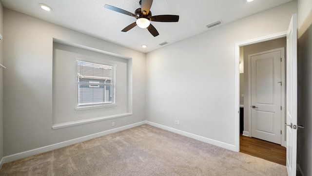 carpeted empty room featuring ceiling fan