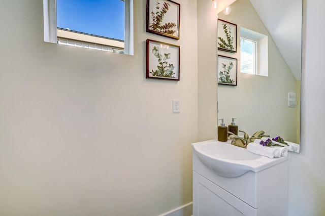 bathroom featuring vanity and vaulted ceiling