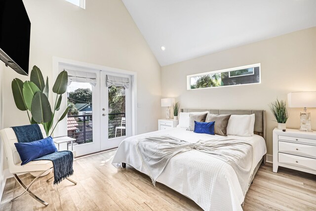 bedroom featuring french doors, light wood-type flooring, access to outside, and multiple windows