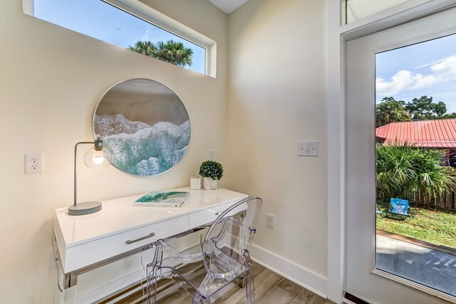 interior space with a wealth of natural light and hardwood / wood-style floors