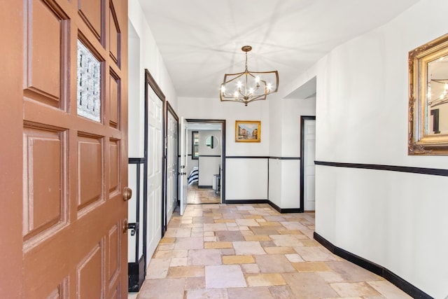 hallway with a notable chandelier