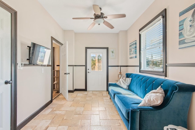 interior space with ceiling fan and a wealth of natural light