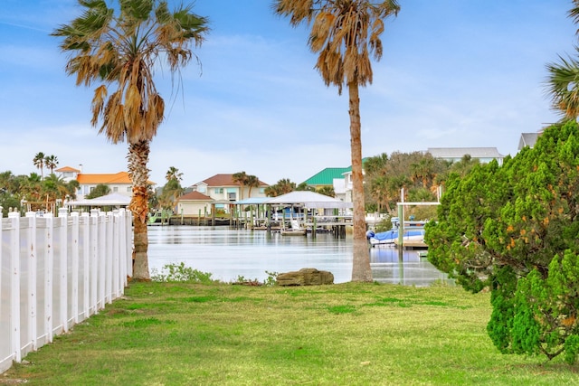 view of yard with a boat dock and a water view