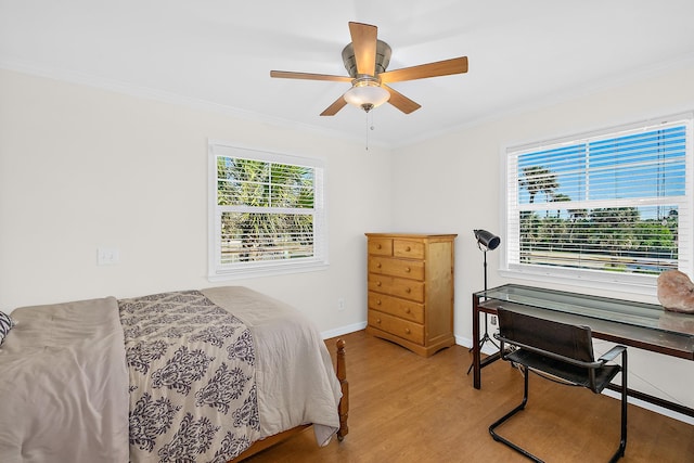 bedroom featuring ceiling fan, crown molding, and light hardwood / wood-style floors