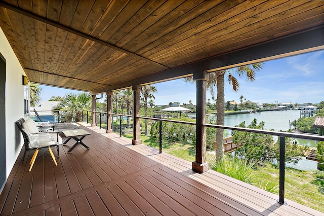 wooden deck featuring a water view