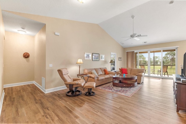 living room featuring lofted ceiling, ceiling fan, and light hardwood / wood-style flooring