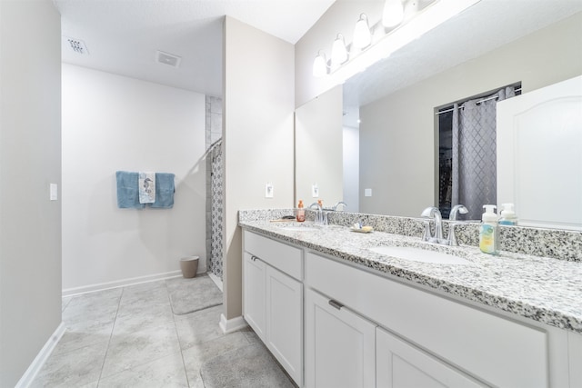 265 Aventurine Ave, Saint Augustine, FL 32086 - bathroom featuring baseboards, a shower with shower curtain, double vanity, and tile patterned flooring